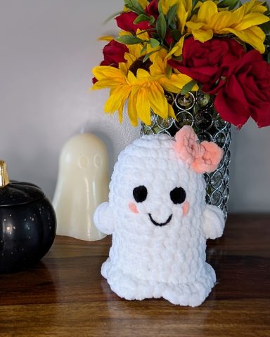 Crochet ghost toy, with a pink hair ribbon